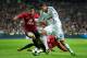 MADRID, SPAIN - FEBRUARY 13: Raphael Varane (R) of Real Madrid duels for the ball with Rafael (L) of Manchester United during the UEFA Champions League Round of 16 first leg match between Real Madrid and Manchester United at Estadio Santiago Bernabeu on February 13, 2013 in Madrid, Spain. (Photo by Jasper Juinen/Getty Images)