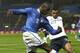 PARMA, ITALY - NOVEMBER 14: Mario Balotelli (L) of Italy competes for the ball with Etienne Capoue of France during the international friendly match between Italy and France at Stadio Ennio Tardini on November 14, 2012 in Parma, Italy. (Photo by Marco Luzzani/Getty Images)