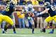 September 8, 2012; Ann Arbor, MI, USA; Air Force Falcons quarterback Connor Dietz (11) runs the ball between Michigan Wolverines defensive tackle Ondre Pipkins (56) and defensive tackle Nathan Brink (67) at Michigan Stadium. Mandatory Credit: Rick Osentoski-USA TODAY Sports