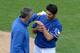 Mar 3, 2013; Surprise, AZ, USA; Texas Rangers relief pitcher Martin Perez (right) is checked out by a trainer after being hit by a line drive back at the mound by Seattle Mariners shortstop Brad Miller (not pictured) during the sixth inning at Surprise Stadium. Mandatory Credit: Jake Roth-USA TODAY Sports