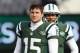 EAST RUTHERFORD, NJ - DECEMBER 23: Quarterbacks Tim Tebow #15 and Mark Sanchez #6, look on as teammate Greg McElroy #14 of the New York Jets passes before the start of their game against the San Diego Chargers at MetLife Stadium on December 23, 2012 in East Rutherford, New Jersey. (Photo by Rich Schultz/Getty Images)