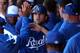 SURPRISE, AZ - FEBRUARY 25: Mike Moustakas #8 of the Kansas City Royals high fives teammates after scoring against the Arizona Diamondbacks during the spring training game at Surprise Stadium on February 25, 2013 in Surprise, Arizona. (Photo by Christian Petersen/Getty Images)