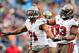 CHARLOTTE, NC - NOVEMBER 18: Michael Bennett #71 and Gerald McCoy #93 of the Tampa Bay Buccaneers celebrate after Bennett's sack of Cam Newton #1 the Carolina Panthers during play at Bank of America Stadium on November 18, 2012 in Charlotte, North Carolina. Tampa Bay won 27-21 in overtime. (Photo by Grant Halverson/Getty Images)