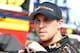DAYTONA BEACH, FL - FEBRUARY 20: Denny Hamlin, driver of the #11 FedEx Express Toyota, stands in the a garage area during practice for the NASCAR Sprint Cup Series Daytona 500 at Daytona International Speedway on February 20, 2013 in Daytona Beach, Florida. (Photo by Todd Warshaw/Getty Images)
