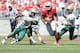 COLUMBUS, OH - SEPTEMBER 22: Braxton Miller #5 of the Ohio State Buckeyes slips past Greg Irvin #7 and Lamarcus Farmer #3, both of the University of Alabama at Birmingham Blazers, during the second quarter on September 22, 2012 at Ohio Stadium in Columbus, Ohio. (Photo by Kirk Irwin/Getty Images)