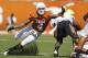 AUSTIN, TX - OCTOBER 15: Safety Kenny Vaccaro #4 of the Texas Longhorns attempts a first quarter tackle of running back Joseph Randall #1 of the Oklahoma State Cowboys on October 15, 2011 at Darrell K. Royal-Texas Memorial Stadium in Austin, Texas. Oklahoma State beat Texas 38-26. (Photo by Erich Schlegel/Getty Images)