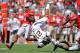 COLUMBUS, OH - SEPTEMBER 15: Keenan Allen #21 of the California Golden Bears is upended as Travis Howard #7 of the Ohio State Buckeyes and Curtis Grant #14 of the Ohio State Buckeyes defend in the first half at Ohio Stadium on September 15, 2012 in Columbus, Ohio. (Photo by Jamie Sabau/Getty Images)