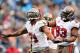 CHARLOTTE, NC - NOVEMBER 18: Michael Bennett #71 and Gerald McCoy #93 of the Tampa Bay Buccaneers celebrate after Bennett's sack of Cam Newton #1 the Carolina Panthers during play at Bank of America Stadium on November 18, 2012 in Charlotte, North Carolina. Tampa Bay won 27-21 in overtime. (Photo by Grant Halverson/Getty Images)