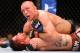 Nov 17, 2012; Montreal, QC, Canada; Georges St-Pierre (top) checks the remaining time left in the fifth round in his Welterweight Championship bout against Carlos Condit (bottom) at UFC 154 at the Bell Centre. St-Pierre defeated Condit by unanimous decision. Mandatory Credit: Eric Bolte-USA TODAY Sports