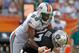 MIAMI GARDENS, FL - DECEMBER 04: Kevin Boss #87 of the Oakland Raiders fights for a loose ball against Karlos Dansby #58 of the Miami Dolphins during a game at Sun Life Stadium on December 4, 2011 in Miami Gardens, Florida. (Photo by Mike Ehrmann/Getty Images)