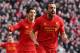 LIVERPOOL, ENGLAND - FEBRUARY 17: Jose Enrique of Liverpool celebrates with Luis Suarez after scoring the third goal during the Barclays Premier League match between Liverpool and Swansea City at Anfield on February 17, 2013 in Liverpool, England. (Photo by Clive Brunskill/Getty Images)