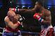 Feb 16, 2013; Atlantic City, NJ, USA; Adrien Broner (Red trunks) and Gavin Rees (Blue/Red trunks) trade punches during their 12 round WBC Lightweight Championship bout at Boardwalk Hall. Mandatory Credit: Ed Mulholland-USA TODAY Sports