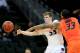 KANSAS CITY, MO - MARCH 15: Will Spradling #55 of the Kansas State Wildcats passes against Marcus Smart #33 of the Oklahoma State Cowboys in the second half during the Semifinals of the Big 12 basketball tournament at the Sprint Center on March 15, 2013 in Kansas City, Missouri. (Photo by Jamie Squire/Getty Images)