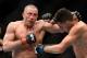 Mar 16, 2013; Montreal, Quebec, CAN; Georges St.Pierre (red) and Nick Diaz (blue) exchange blows during their Welterweight title bout at UFC 158 at the Bell Centre. Mandatory Credit: Eric Bolte-USA TODAY Sports