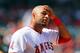 ANAHEIM, CA - SEPTEMBER 13: Vernon Wells #10 of the Los Angeles Angels of Anaheim wipes his forehead after reaching first base on an infield single during a break in action in the seventh inning of the MLB game against the Oakland Athletics at Angel Stadium of Anaheim on September 13, 2012 in Anaheim, California. (Photo by Victor Decolongon/Getty Images)