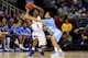 KANSAS CITY, MO - MARCH 24: Naadir Tharpe #1 of the Kansas Jayhawks looks to pass against Marcus Paige #5 of the North Carolina Tar Heels during the third round of the 2013 NCAA Men's Basketball Tournament at Sprint Center on March 24, 2013 in Kansas City, Missouri. (Photo by Jamie Squire/Getty Images)