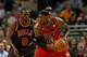 Luol Deng attempts to place the clamps on LeBron James.