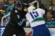 SAN JOSE, CA - JANUARY 27: Douglas Murray #3 of the San Jose Sharks fights with Aaron Volpatti #15 of the Vancouver Canucks in the third period of their game at HP Pavilion on January 27, 2013 in San Jose, California. The Sharks won the game 4-1. (Photo by Thearon W. Henderson/Getty Images)