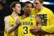 ARLINGTON, TX - MARCH 29: Trey Burke #3 of the Michigan Wolverines reacts after shooting a game tying three pointer with teammates in the final seconds of the second half againist the Kansas Jayhawks during the South Regional Semifinal round of the 2013 NCAA Men's Basketball Tournament at Dallas Cowboys Stadium on March 29, 2013 in Arlington, Texas. (Photo by Tom Pennington/Getty Images)