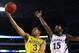 ARLINGTON, TX - MARCH 29: Trey Burke #3 of the Michigan Wolverines goes up against Elijah Johnson #15 of the Kansas Jayhawks in overtime during the South Regional Semifinal round of the 2013 NCAA Men's Basketball Tournament at Dallas Cowboys Stadium on March 29, 2013 in Arlington, Texas. (Photo by Tom Pennington/Getty Images)