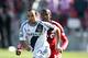 TORONTO, CANADA - MARCH 30: Landon Donovan #10 of the Los Angeles Galaxy chases after the ball with Jeremy Hall #25 of the Toronto FC in an MLS game on March 30, 2013 at BMO Field in Toronto, Ontario, Canada. The Los Angeles Galaxy and Toronto FC played to a 2-2 tie. (Photo by Claus Andersen/Getty Images)