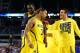 ARLINGTON, TX - MARCH 29: Trey Burke #3 of the Michigan Wolverines celebrates their 87 to 85 win over the Kansas Jayhawks in overtime with teammates during the South Regional Semifinal round of the 2013 NCAA Men's Basketball Tournament at Dallas Cowboys Stadium on March 29, 2013 in Arlington, Texas. (Photo by Tom Pennington/Getty Images)