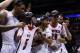 Mar 31, 2013; Indianapolis, IN, USA; Louisville Cardinals players including Chane Behanan (left) celebrate with the midwest regional championship trophy and the jersey of injured teammate Kevin Ware (5) after the finals of the Midwest regional of the 2013 NCAA tournament against the Duke Blue Devils at Lucas Oil Stadium. Louisville won 85-63. Mandatory Credit: Brian Spurlock-USA TODAY Sports