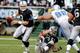 OAKLAND, CA - DECEMBER 18: Carson Palmer #3 of the Oakland Raiders scrambles away from Ndamukong Suh #90 of the Detroit Lions at O.co Coliseum on December 18, 2011 in Oakland, California. (Photo by Thearon W. Henderson/Getty Images)