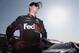 FONTANA, CA - MARCH 22: Denny Hamlin, driver of the #11 FedEx Express Toyota, stands on the grid after qualifying for the NASCAR Sprint Cup Series Auto Club 400 at Auto Club Speedway on March 22, 2013 in Fontana, California. (Photo by Jeff Gross/Getty Images)
