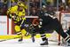 March 17, 2012; Detroit, MI, USA; Michigan Wolverines forward David Wohlberg (25) is defended by Western Michigan Broncos defenseman Dan DeKeyser (5) in the first period at Joe Louis Arena. Mandatory Credit: Rick Osentoski-USA TODAY Sports