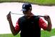 ORLANDO, FL - MARCH 24: Tiger Woods bites his putter following a putt on the 18th hole during the final round of the Arnold Palmer Invitational presented by MasterCard at the Bay Hill Club and Lodge on March 25, 2013 in Orlando, Florida. (Photo by Sam Greenwood/Getty Images)