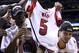 INDIANAPOLIS, IN - MARCH 31: (L-R) Russ Smith #2 and Peyton Siva #3 of the Louisville Cardinals celebrate with the Midwest Regional CHampionship trophy as a teammate holds up a #5 jersey belonging to teammate Kevin Ware as they celebrate after they won 85-63 against the Duke Blue Devils during the Midwest Regional Final round of the 2013 NCAA Men's Basketball Tournament at Lucas Oil Stadium on March 31, 2013 in Indianapolis, Indiana. Ware suffered a compound fracture of his leg in the first half. (Photo by Streeter Lecka/Getty Images)