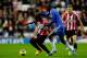 SUNDERLAND, ENGLAND - DECEMBER 8: Stephane Sessegnon (L) of Sunderland in action with Ramires of Chelsea during the Barclays Premier League match between Sunderland and Chelsea at the Stadium of Light on December 8, 2012, in Sunderland, England. (Photo by Paul Thomas/Getty Images)