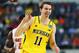 ARLINGTON, TX - MARCH 31: Nik Stauskas #11 of the Michigan Wolverines celebrates after shooting a three poniter in the first half against the Florida Gators during the South Regional Round Final of the 2013 NCAA Men's Basketball Tournament at Dallas Cowboys Stadium on March 31, 2013 in Arlington, Texas. (Photo by Tom Pennington/Getty Images)