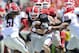 Apr 6, 2013; Athens, GA, USA; Georgia Bulldogs red team quarterback Aaron Murray (11) is stopped by black team linebackers Ramik Wilson (51) and James DeLoach (89) during the Georgia Spring Day Game at Sanford Stadium. Mandatory Credit: Dale Zanine-USA TODAY Sports
