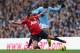 MANCHESTER, ENGLAND - DECEMBER 09: Rafael of Manchester United competes with Mario Balotelli of Manchester City during the Barclays Premier League match between Manchester City and Manchester United at the Etihad Stadium on December 9, 2012 in Manchester, England. (Photo by Clive Mason/Getty Images)
