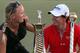 DUBAI, UNITED ARAB EMIRATES - NOVEMBER 25: Caroline Wozniacki of Denmark and Rory McIlroy of Northern Ireland with the DP World Tour Championship and The Race to Dubai trophy on the 18th green during the final roung of the DP World Tour Championship on the Earth Course at Jumeirah Golf Estates on November 25, 2012 in Dubai, United Arab Emirates. (Photo by Ross Kinnaird/Getty Images)