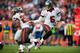 DENVER, CO - DECEMBER 2: Quarterback Josh Freeman #5 hands off to running back Doug Martin #22 of the Tampa Bay Buccaneers during a game against the Denver Broncos at Sports Authority Field Field at Mile High on December 2, 2012 in Denver, Colorado. (Photo by Dustin Bradford/Getty Images)