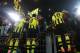 Getty Images. Dortmund players climbed the fence to celebrate with fans after the match.