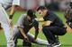 PHOENIX, AZ - APRIL 08: Head athletic trainer Tom Tomczyk of the Pittsburgh Pirates takes a look at starting pitcher Wandy Rodriguez #51 after Tomczyk injured his leg against the Arizona Diamondbacks at Chase Field on April 8, 2013 in Phoenix, Arizona. (Photo by Norm Hall/Getty Images)