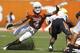AUSTIN, TX - OCTOBER 15: Safety Kenny Vaccaro #4 of the Texas Longhorns attempts a first quarter tackle of running back Joseph Randall #1 of the Oklahoma State Cowboys on October 15, 2011 at Darrell K. Royal-Texas Memorial Stadium in Austin, Texas. Oklahoma State beat Texas 38-26. (Photo by Erich Schlegel/Getty Images)