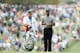 AUGUSTA, GA - APRIL 11: Tiger Woods of the United States stands with caddie Joe LaCava on the first hole during the first round of the 2013 Masters Tournament at Augusta National Golf Club on April 11, 2013 in Augusta, Georgia. (Photo by Andrew Redington/Getty Images)