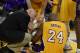 Apr 12, 2013; Los Angeles, CA, USA; Los Angeles Lakers shooting guard Kobe Bryant (24) is looked at by a medical staff member against the Golden State Warriors during the game at Staples Center. Mandatory Credit: Richard Mackson-USA TODAY Sports