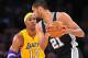 November 13, 2012; Los Angeles, CA, USA; Los Angeles Lakers center Dwight Howard (12) defends San Antonio Spurs power forward Tim Duncan (21) during the first half at Staples Center. Mandatory Credit: Gary A. Vasquez-USA TODAY Sports