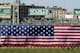 BOSTON, MA - APRIL 20: A giant flag covers the Green Monster as the national anthem is played before the game between the New York Yankees and the Boston Red Sox on April 20, 2012 at Fenway Park in Boston, Massachusetts. Today marks the 100 year anniversary of the ball park's opening. (Photo by Elsa/Getty Images)