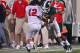 EAST LANSING, MI - SEPTEMBER 02: Johnny Adams #5 of the Michigan State Spartans puts a shoulder hit on Kurt Hess #12 of the Youngstown State Penguins during an NCAA football game at Spartan Stadium on September 2, 2011 in East Lansing, Michigan. The Spartans won 28-6 (Photo by Dave Reginek/Getty Images)