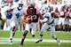 CHAPEL HILL, NC - OCTOBER 06: Corey Fuller #83 of the Virginia Tech Hokies avoids a tackle by Jabari Price #4 and Darien Rankin #27 of the North Carolina Tar Heels on October 6, 2012 at Kenan Stadium in Chapel Hill, North Carolina. (Photo by Lance King/Getty Images)