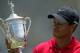 SAN DIEGO - JUNE 16: Tiger Woods celebrates with the trophy after winning on the first sudden death playoff hole during the playoff round of the 108th U.S. Open at the Torrey Pines Golf Course (South Course) on June 16, 2008 in San Diego, California. (Photo by Doug Pensinger/Getty Images)