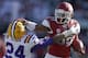 FAYETTEVILLE, AR - NOVEMBER 23: Dennis Johnson #33 of the Arkansas Razorbacks stiff arms Tharold Simon #24 of the LSU Tigers at Razorback Stadium on November 23, 2012 in Fayetteville, Arkansas. (Photo by Wesley Hitt/Getty Images)