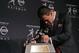 2012 Heisman winner Johnny Manziel kisses his award